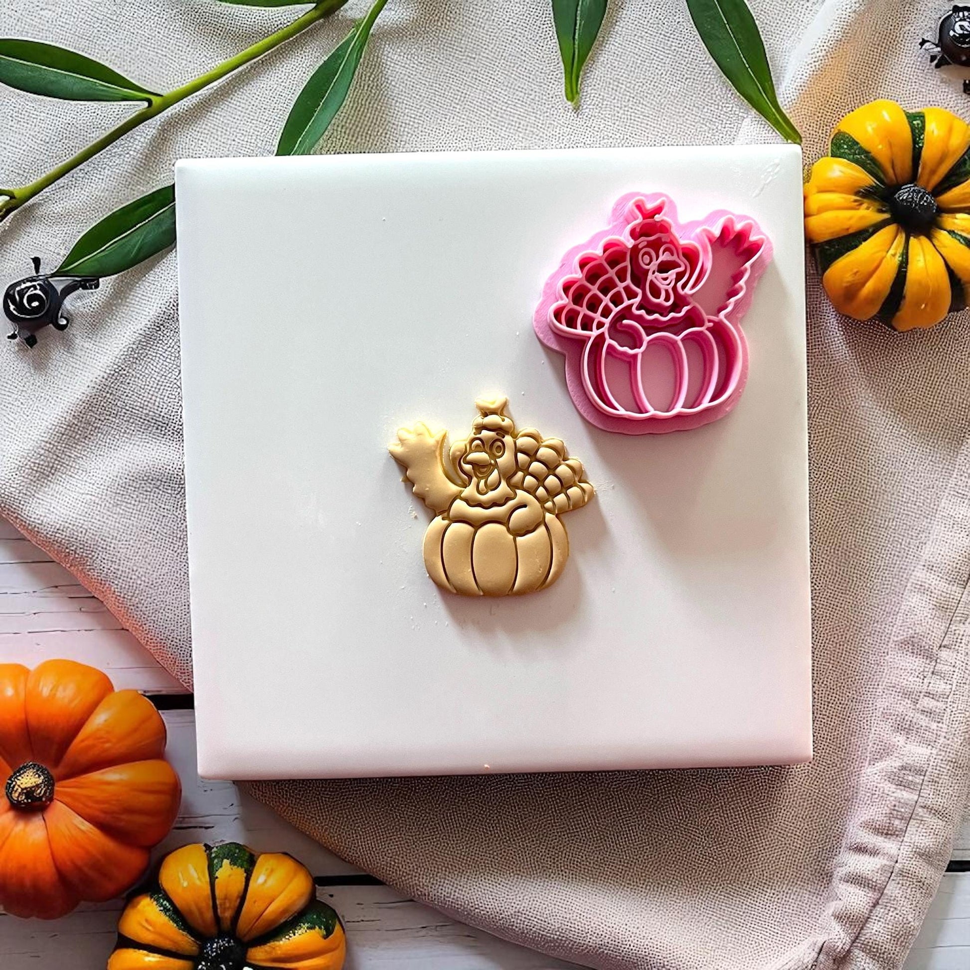 Cutter and clay turkey pumpkin design side by side