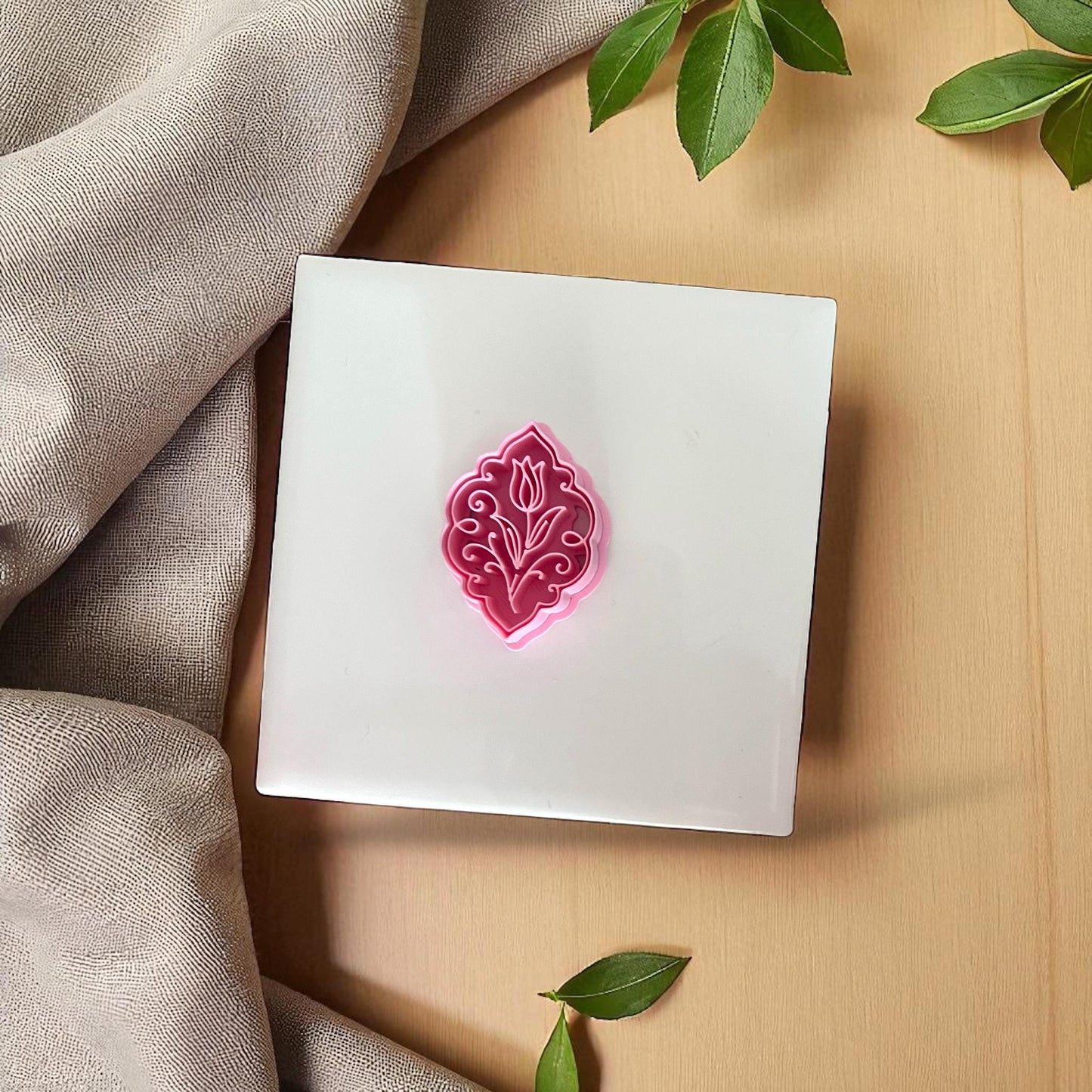 Pink tulip ornament clay cutter on white tile
