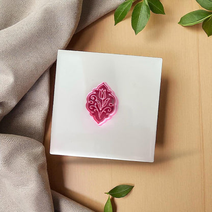 Pink tulip ornament clay cutter on white tile
