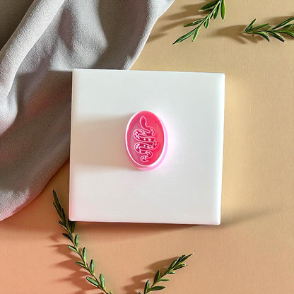 Pink snake clay cutter on white tile with leaves