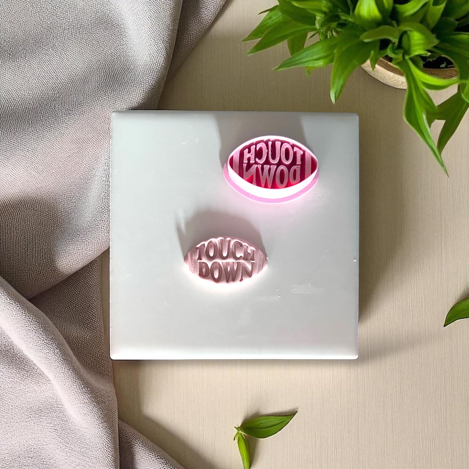 Pink touchdown football cutter flipped upside down