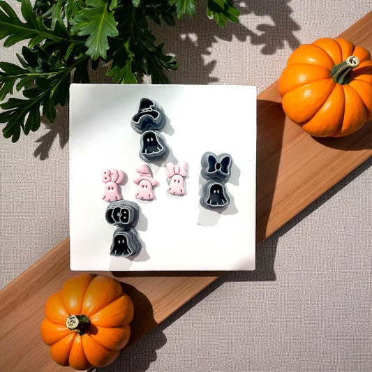 Three small pink ghost clay shapes with bow, witch hat, and boo
