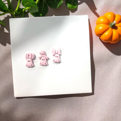 Pink clay slab with ghost impressions of bow, witch hat, and boo