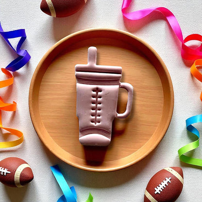 Large football Stanley cup clay piece on round wood plate with footballs