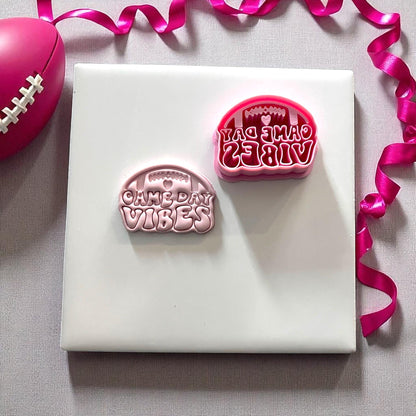 Pink cutter and clay imprint reading game day vibes with football