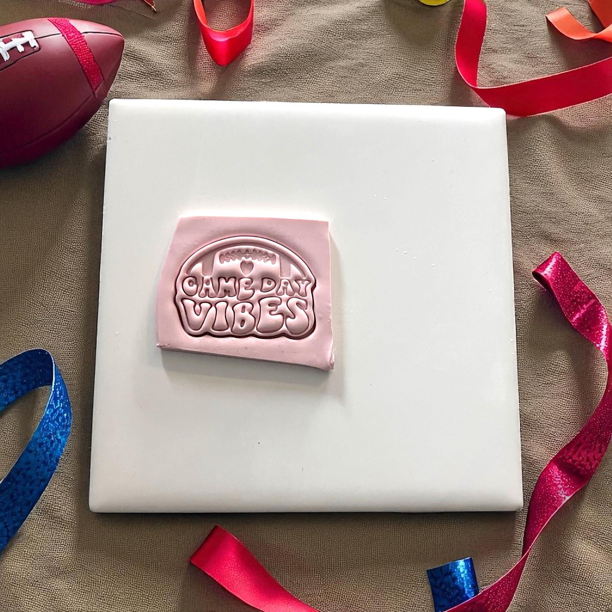 Pink clay with football game day vibes design pressed