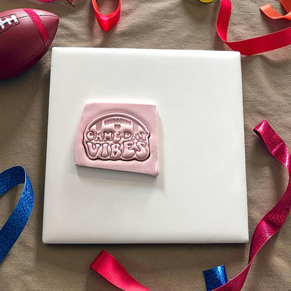 Pink clay with football game day vibes design pressed
