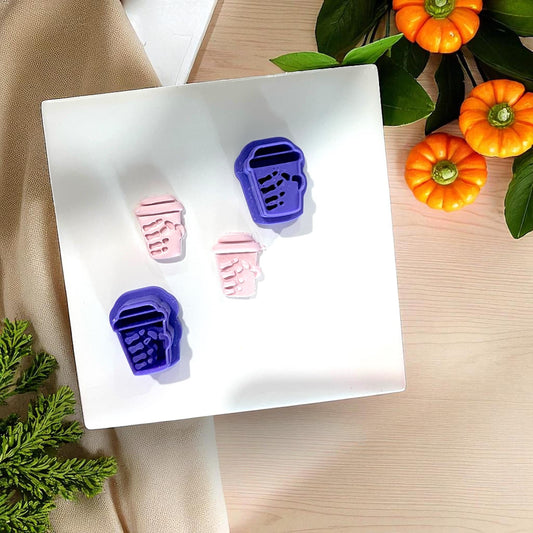 Purple cutters and pink clay skeleton coffee cups with pumpkins