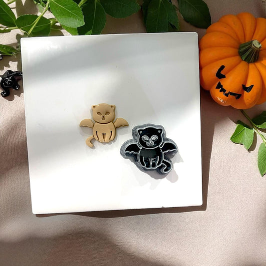 Vampire kitten clay piece and cutter side by side with pumpkin