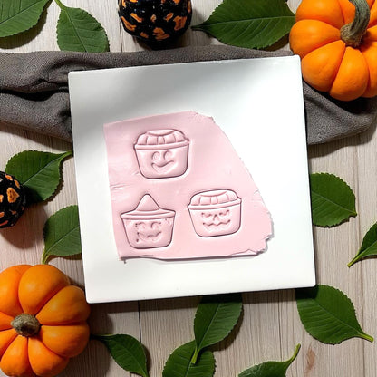 Pink clay with three pumpkin bucket face impressions