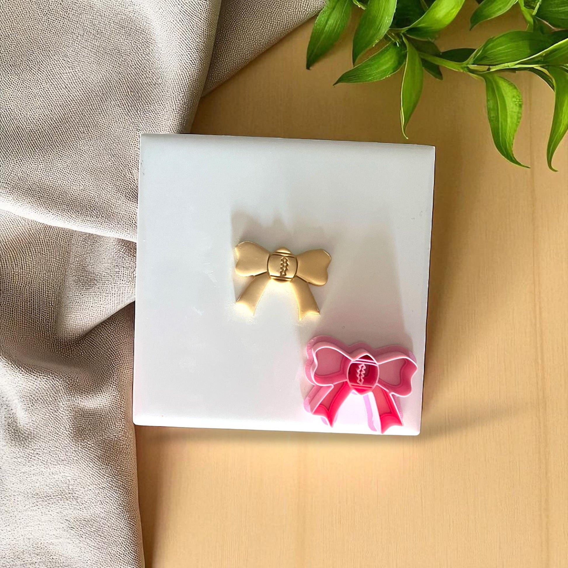 Gold and pink football bow cutter with clay impress