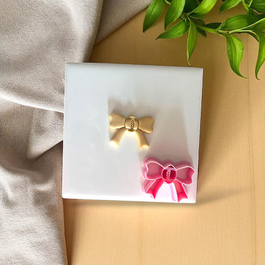 Gold and pink football bow cutter with clay impress