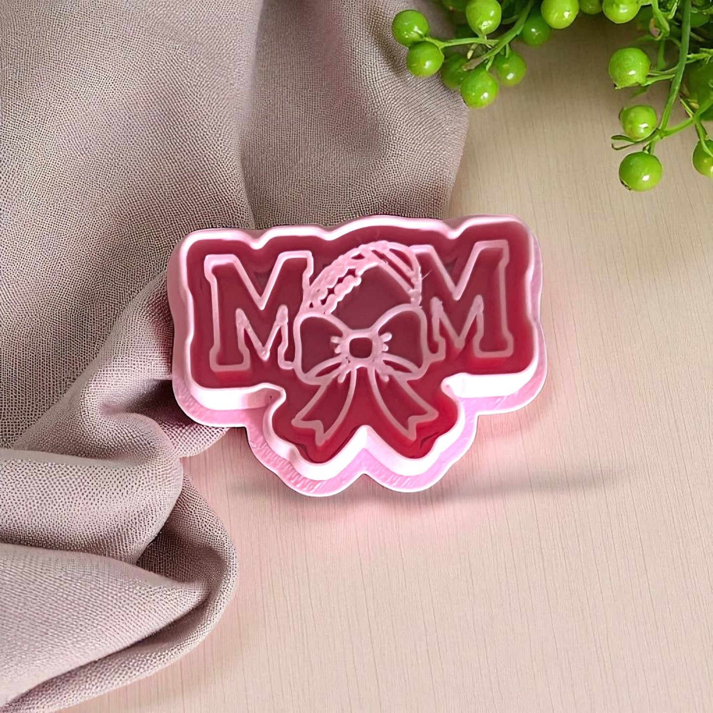 Pink football mom polymer clay cutter with bow detail