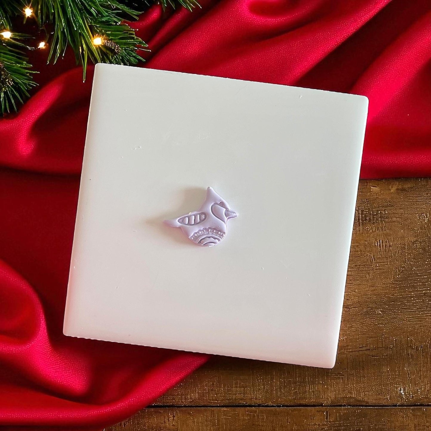 Small clay imprint of a holiday bird design