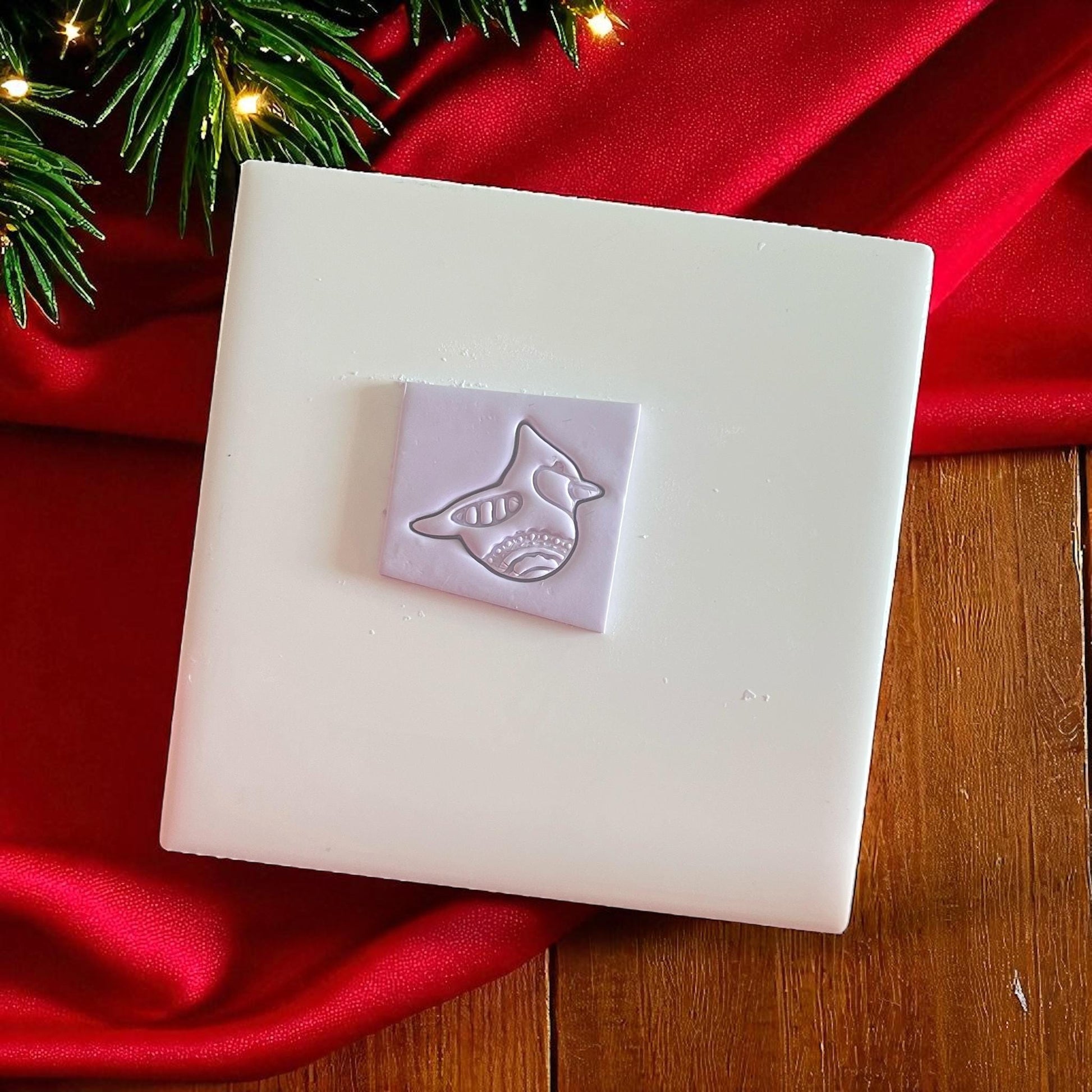 Cardinal bird polymer clay imprint with festive details