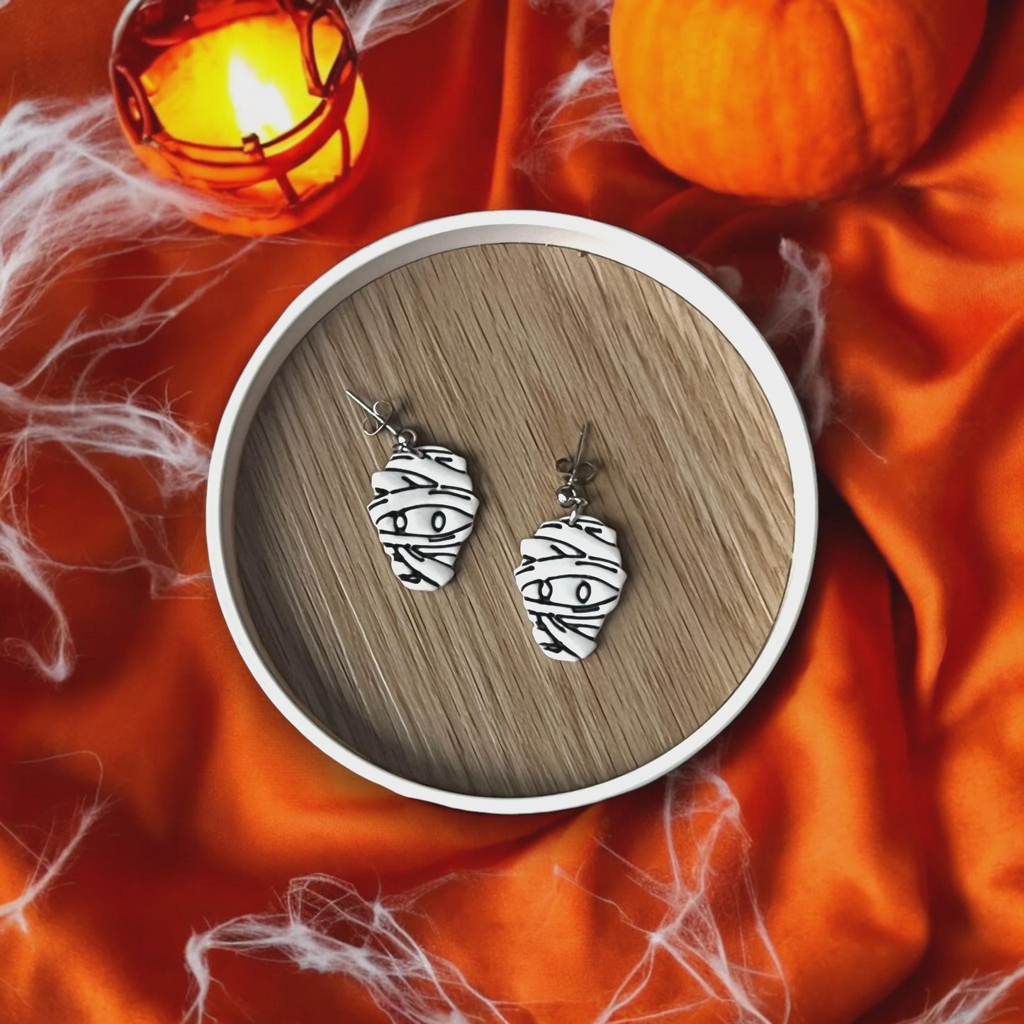 Finished Mummy earrings on Spooky Background