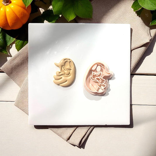 Side by side ghost clay cutter and ghost clay shape on white tile