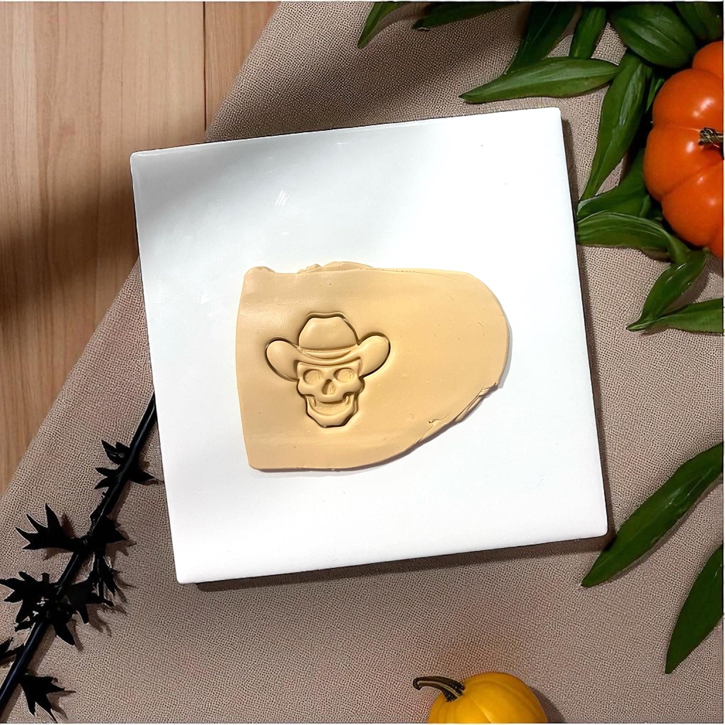 Cowboy skull clay imprint in slab with pumpkins and leaves