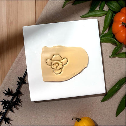 Cowboy skull clay imprint in slab with pumpkins and leaves