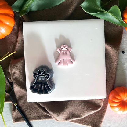 Cowboy ghost cutter and clay piece on tile with pumpkins