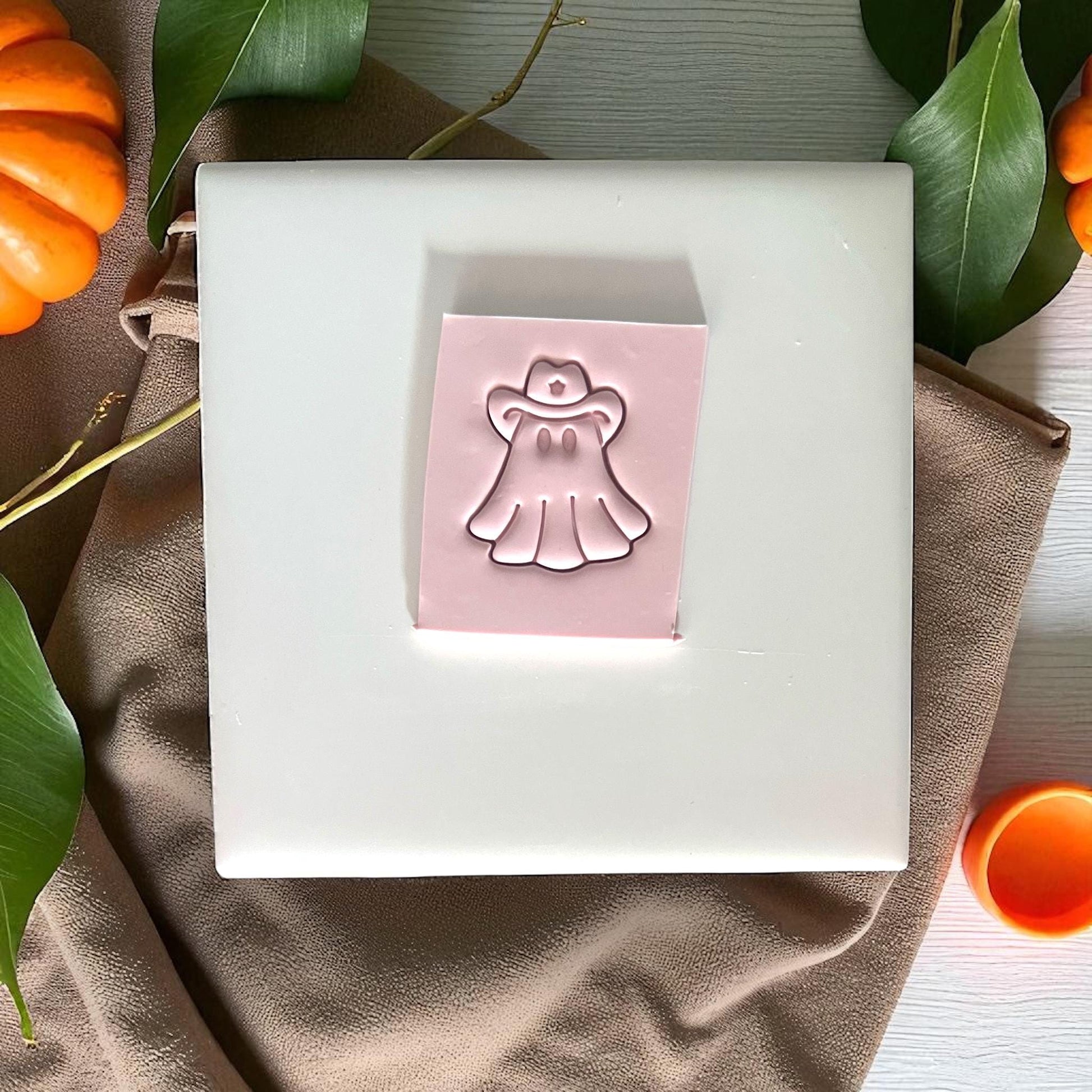 Cowboy ghost clay imprint on slab with pumpkins