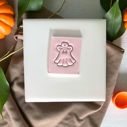 Cowboy ghost clay imprint on slab with pumpkins