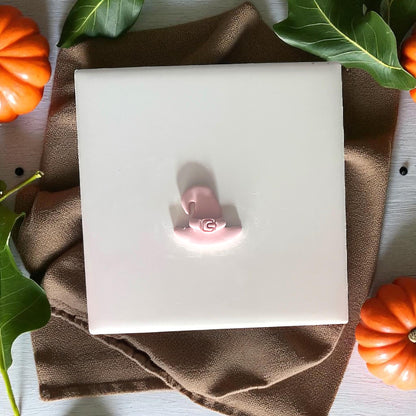 Witch hat cutter and clay piece shown on tile with pumpkins