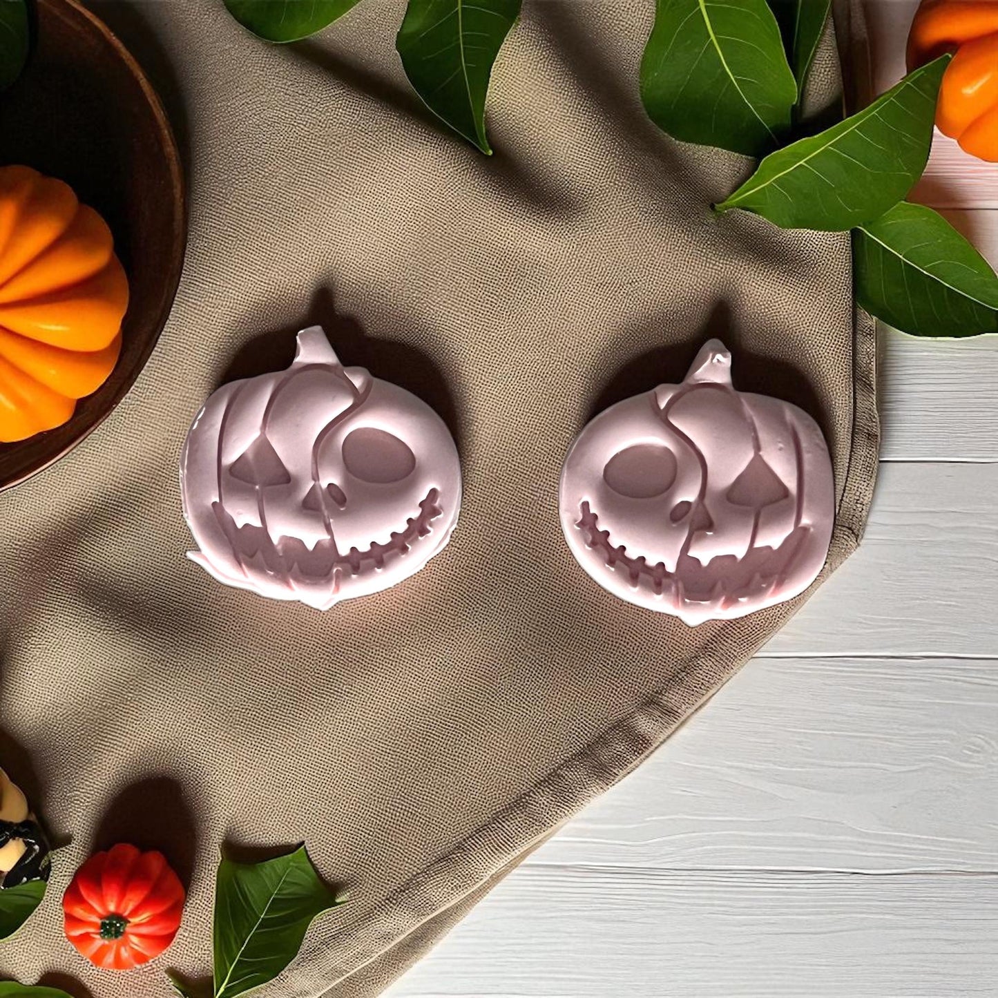 Pink pumpkin skull clay designs with greenery and pumpkins