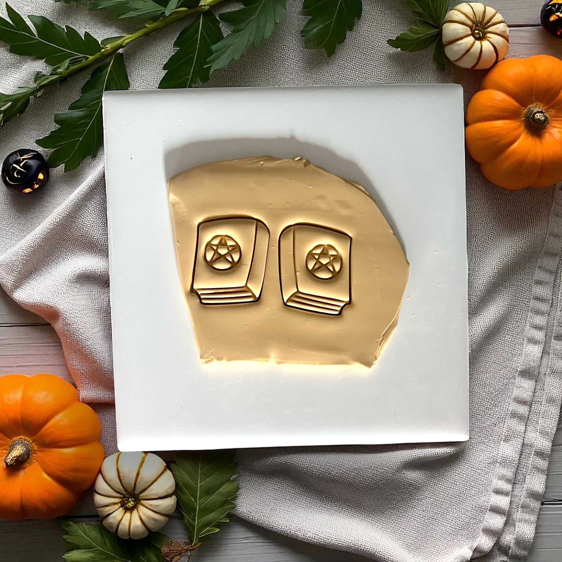 Spellbook clay imprints with pentagram design on yellow clay