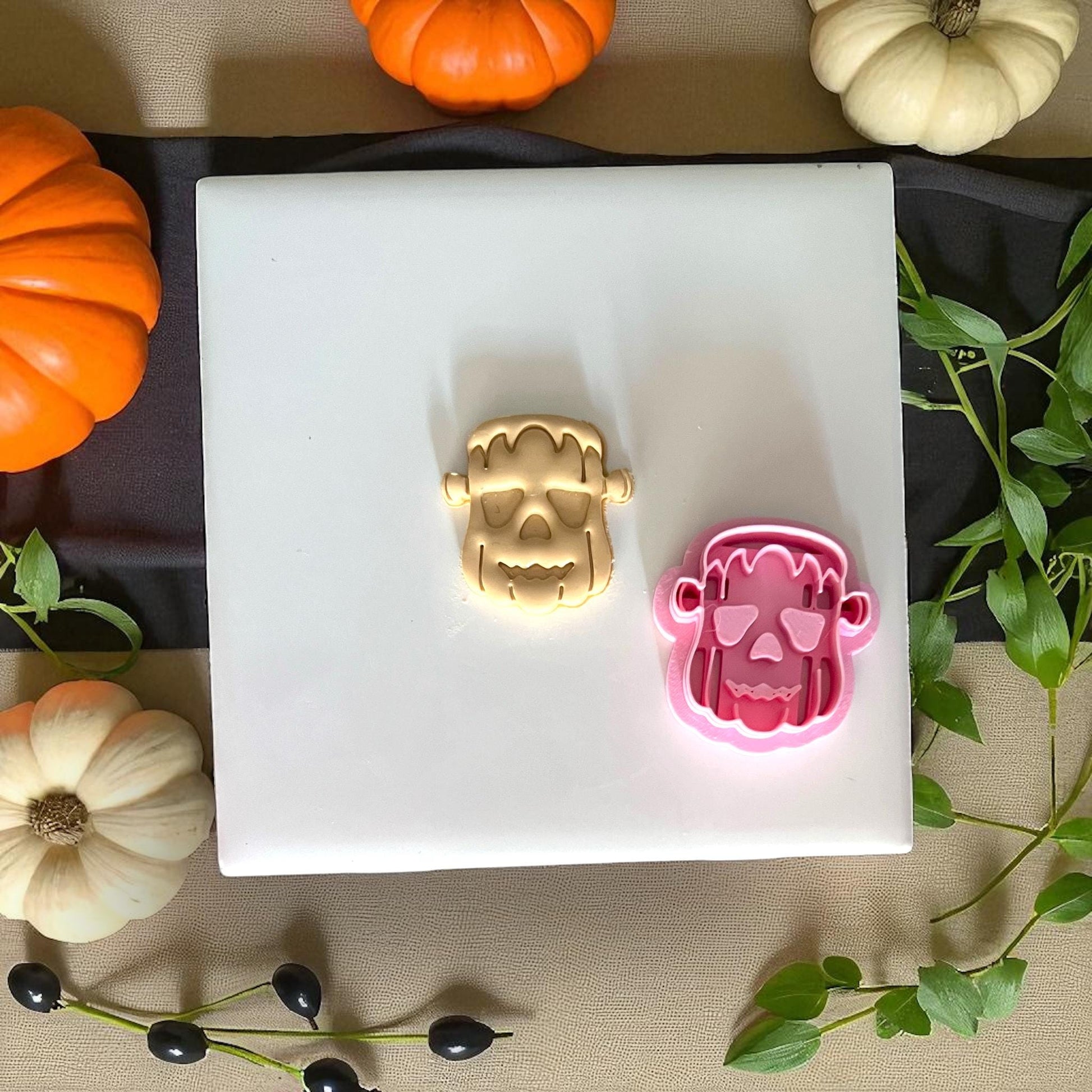 Frankenstein pumpkin clay imprint and pink cutter side by side