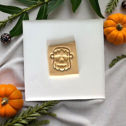 Frankenstein pumpkin face design imprinted in clay