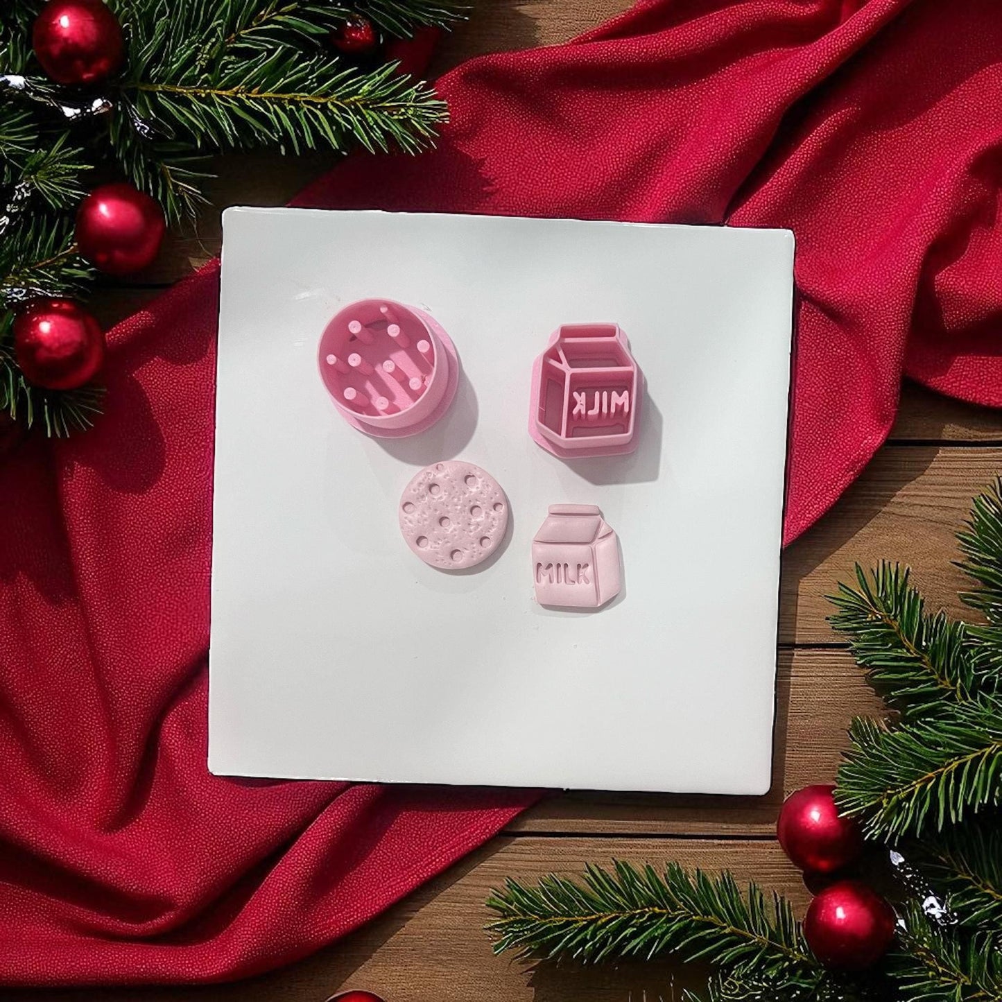 Milk and cookie polymer clay cutters with imprints on white board