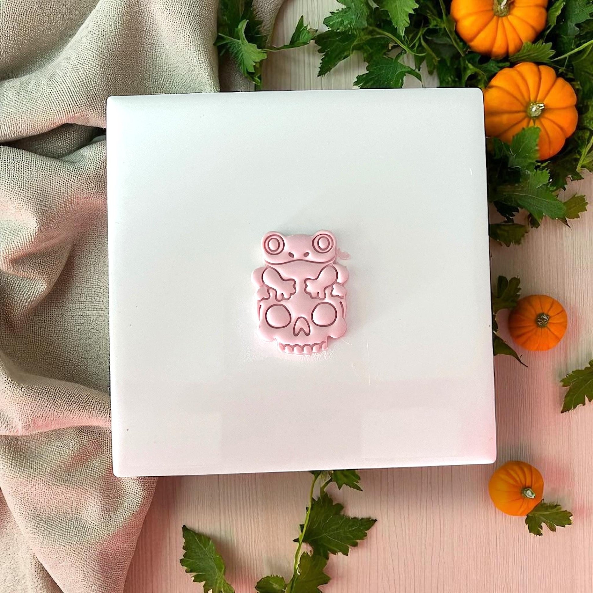 Finished pink frog on skull clay piece with pumpkins