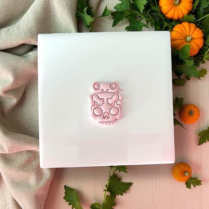 Finished pink frog on skull clay piece with pumpkins