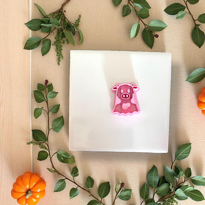 Pink ghost cow clay cutter on white tile