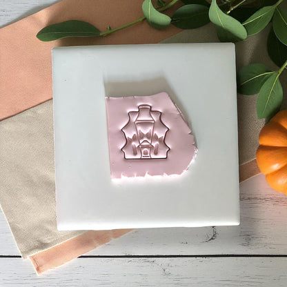 Haunted house clay impression on pink clay