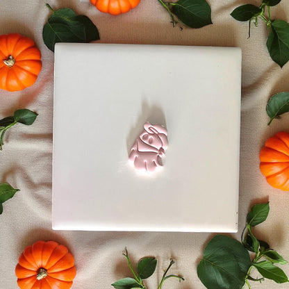 Small cowboy ghost clay piece on white tile