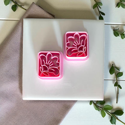 Two square floral clay cutters with tropical hibiscus design