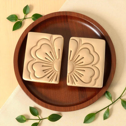 Rectangular floral clay imprints on wooden plate