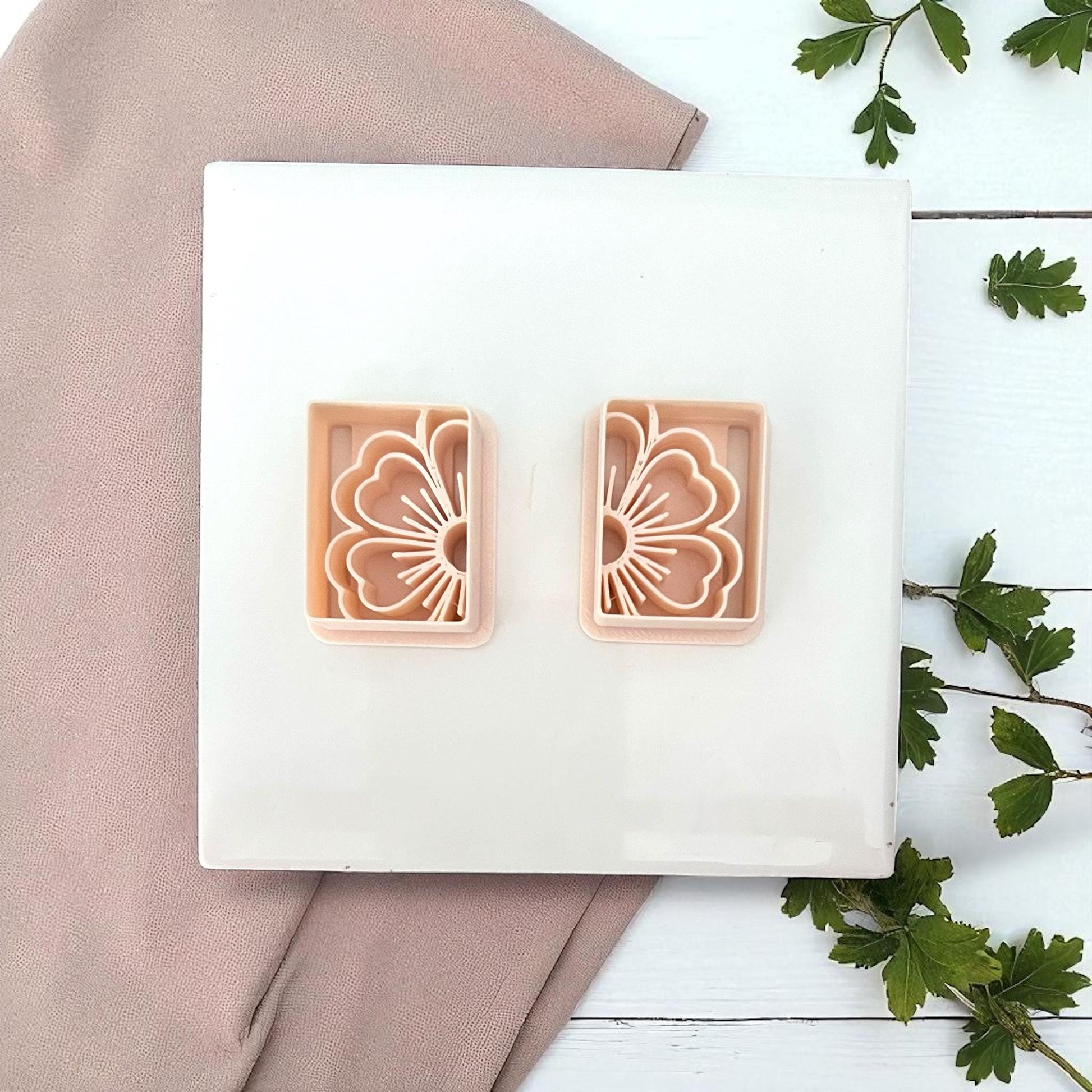 Rectangular floral polymer clay cutters on white tile