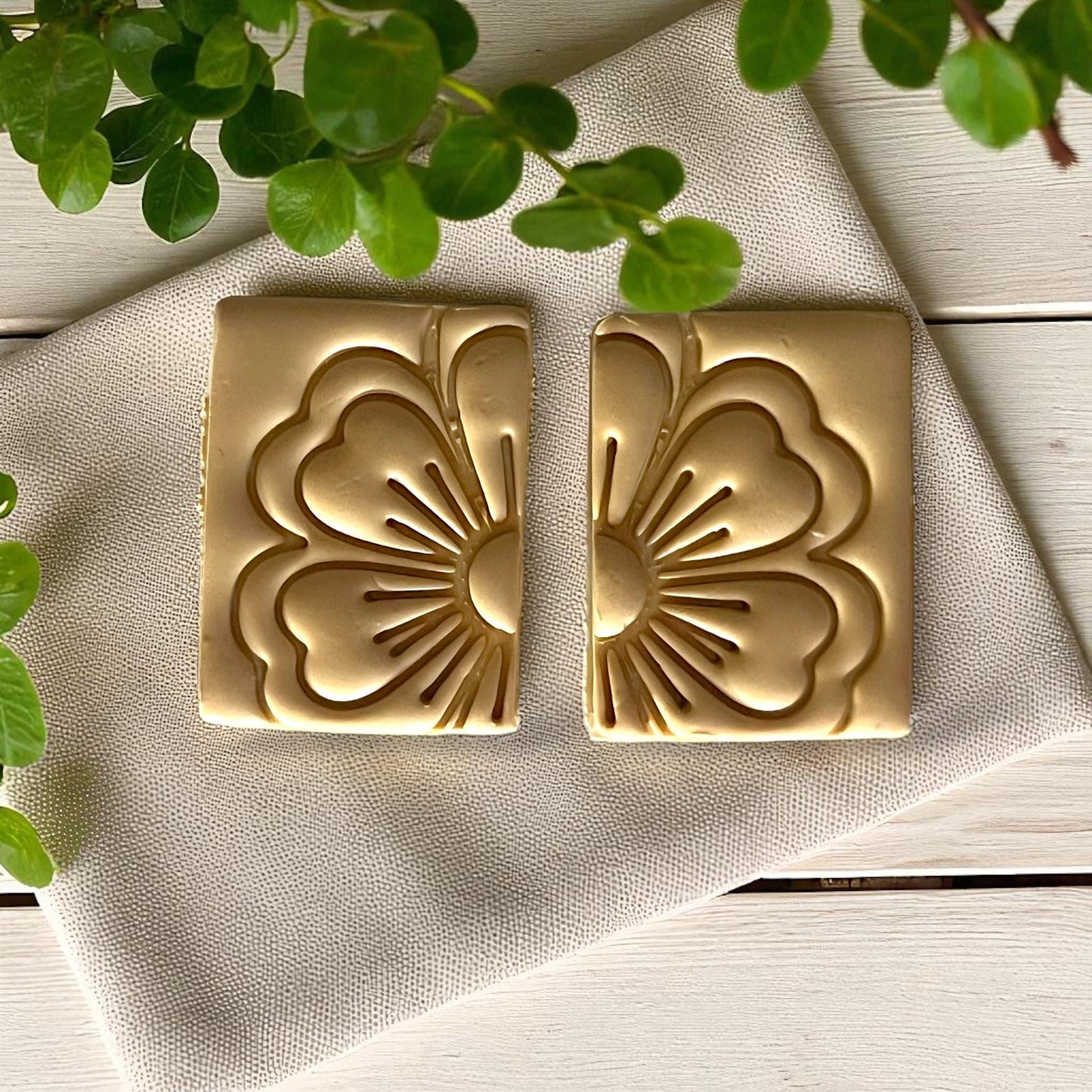 Closeup of rectangular flower clay imprints on fabric