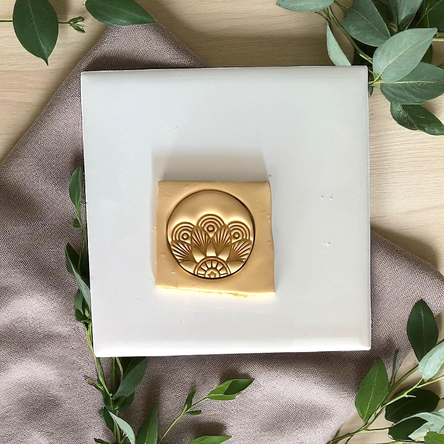 Round Art Deco polymer clay cutter on white tile