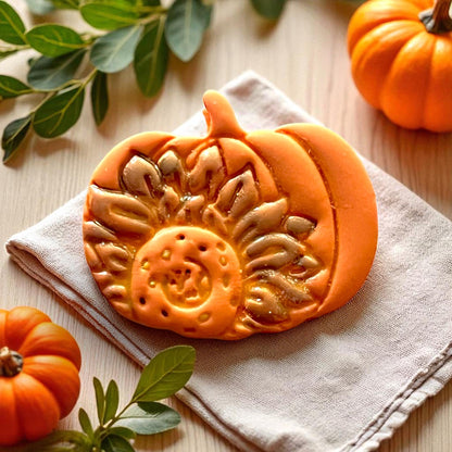 Pumpkin clay piece with sunflower design in warm tones