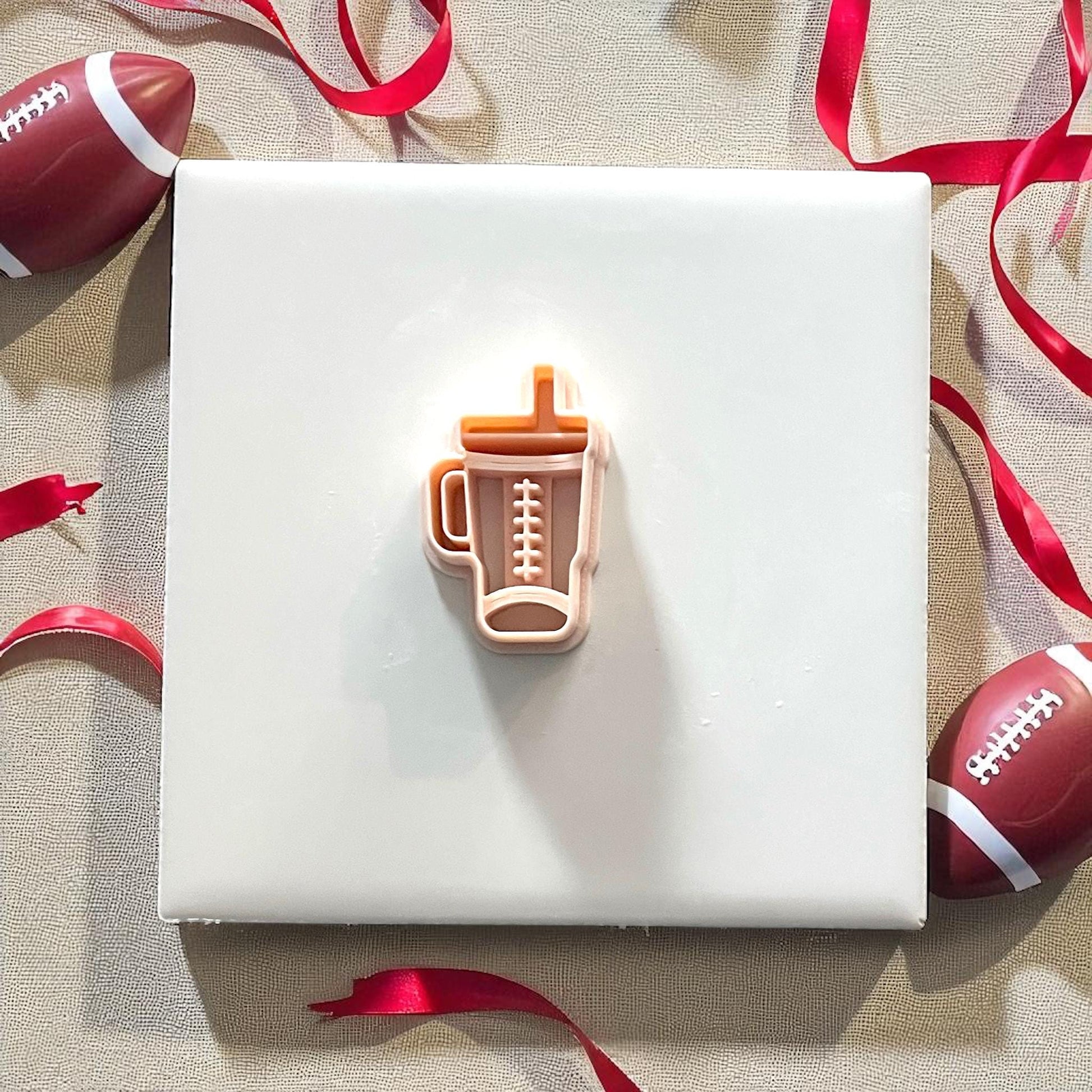 Orange football Stanley cup clay cutter with pink impression