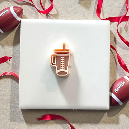 Orange football Stanley cup clay cutter with pink impression
