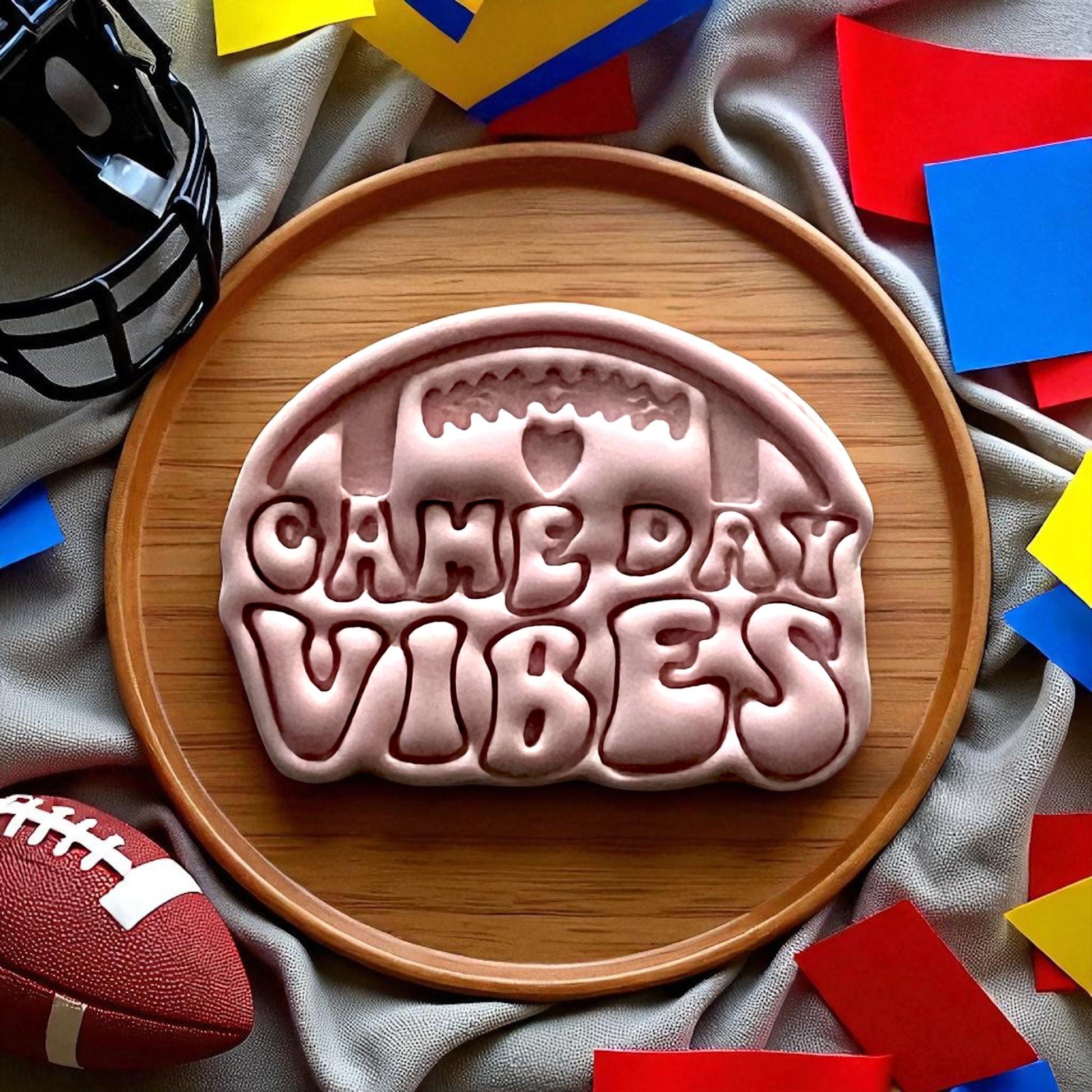 Large clay cutout with football game day vibes letters on plate