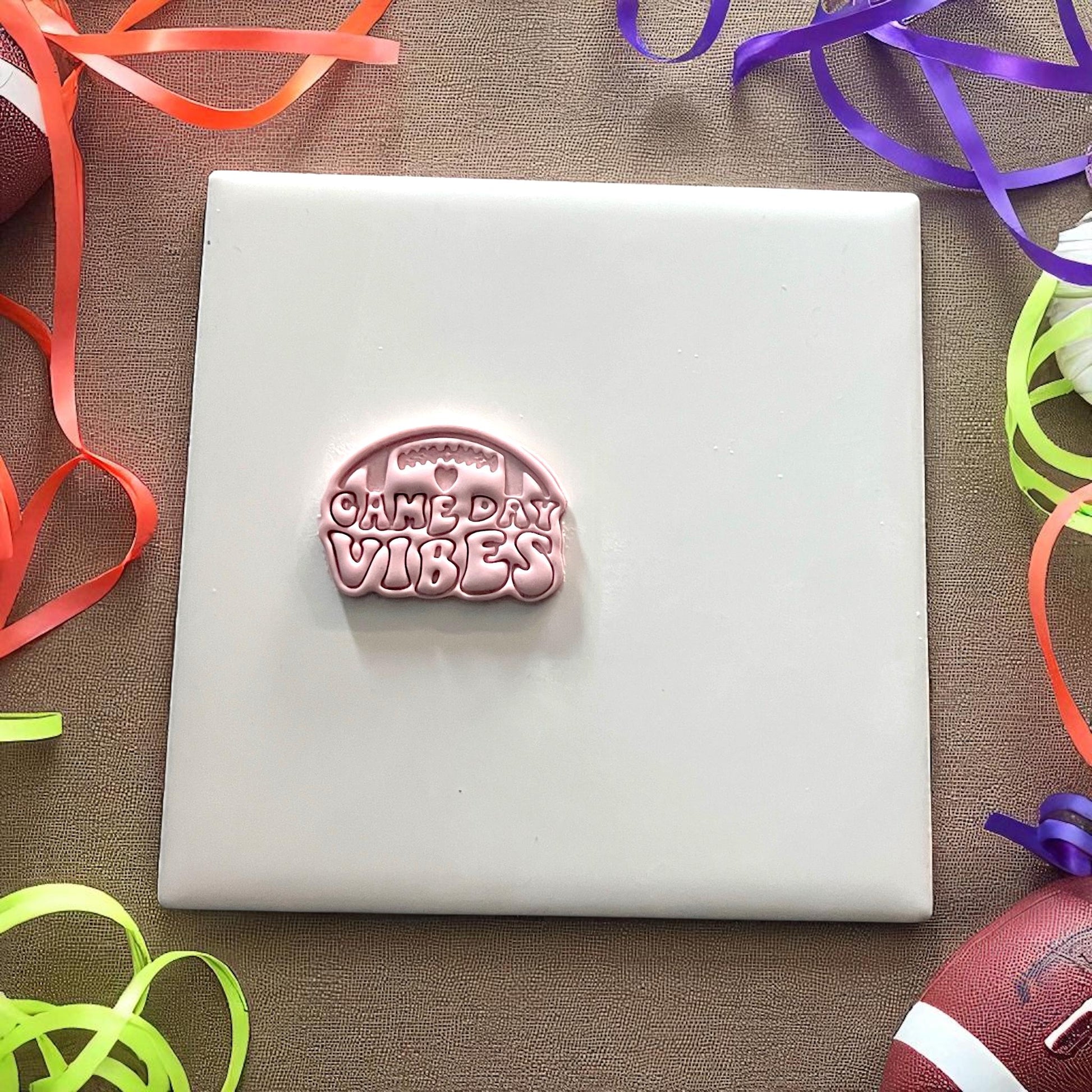 Small football game day vibes clay imprint on tile with rainbow ribbons