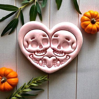 Large pink skeleton couple heart clay piece with pumpkins and leaves