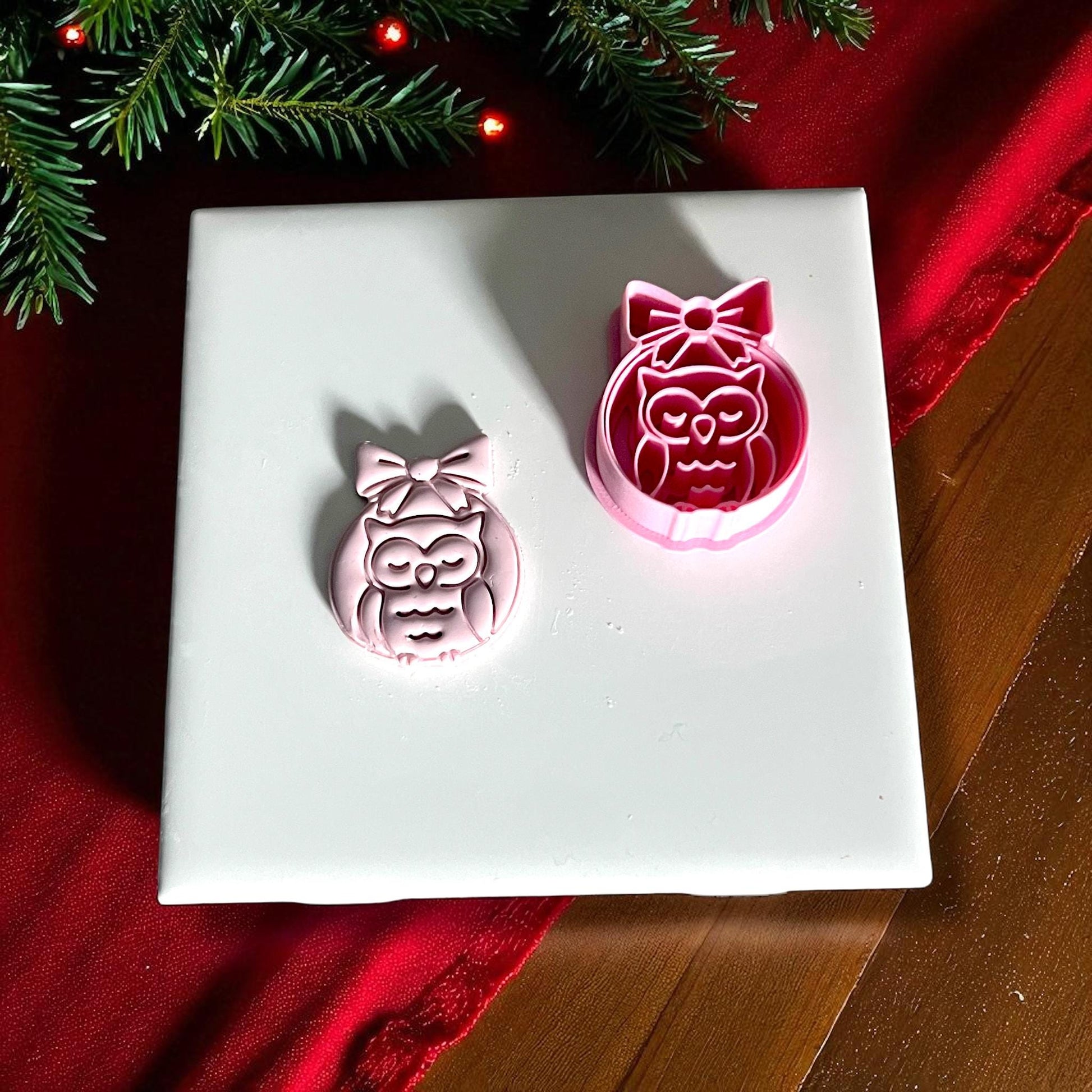 Owl ornament clay imprint beside pink polymer clay cutter