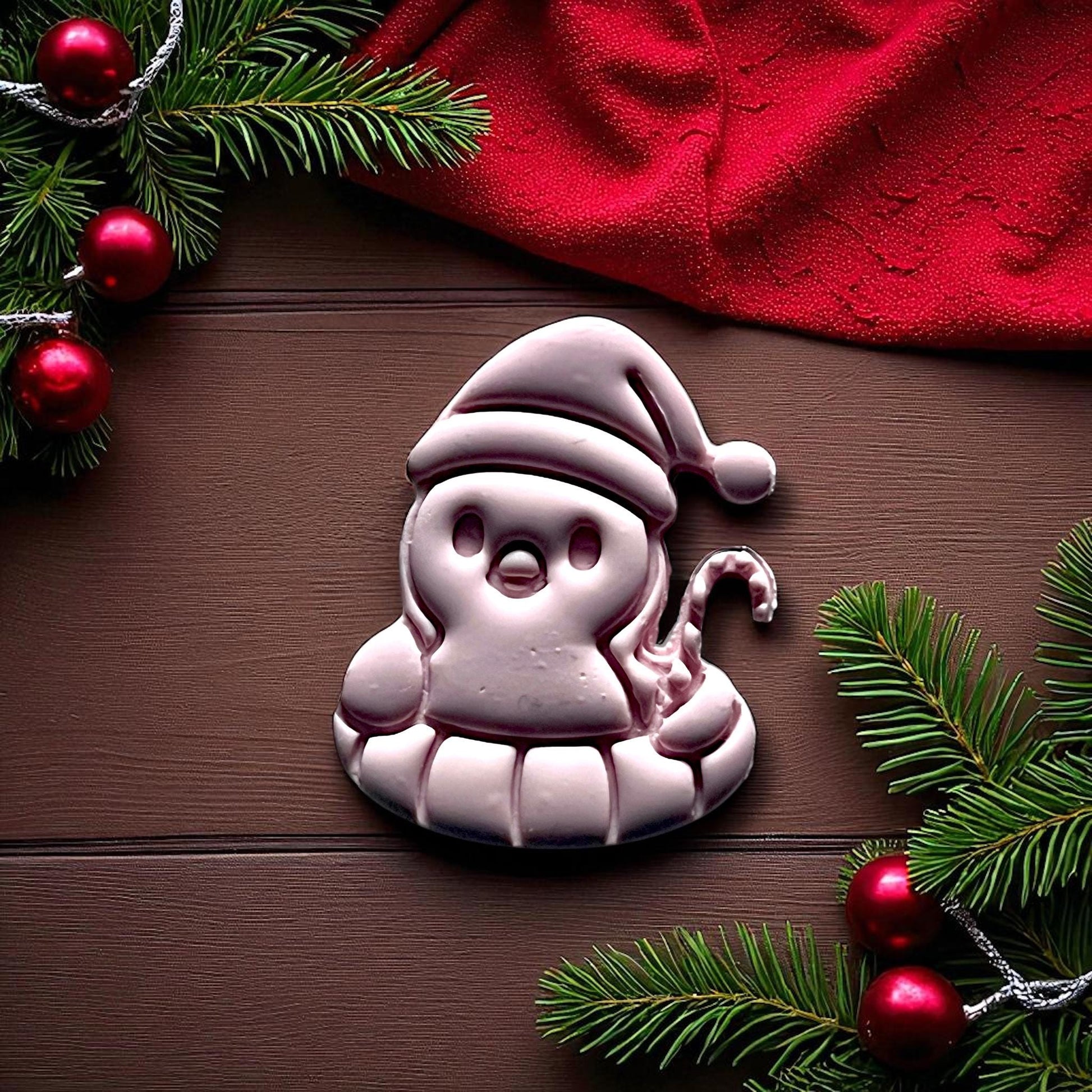 Penguin Christmas clay imprint on wood with greenery and ornaments